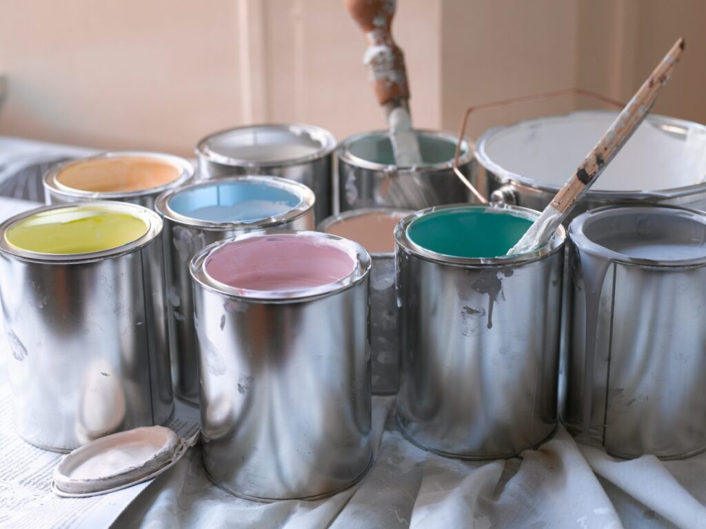 Colorful paint cans and brush