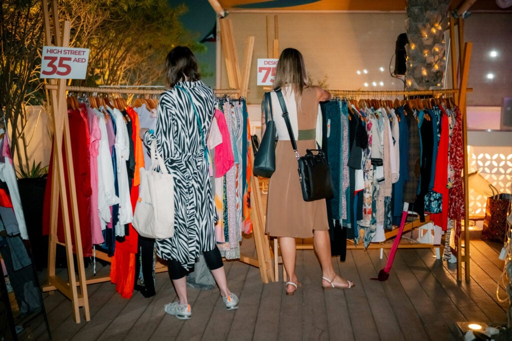 Two women shopping at clothing rack