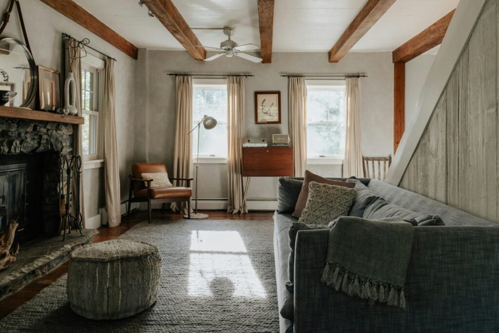 a comfortable home with throws and rugs and wooden beams 