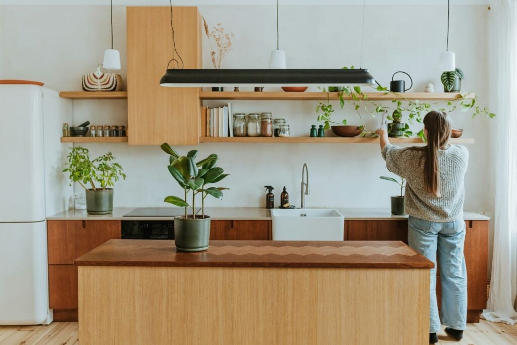 Modern kitchen with plants and woman