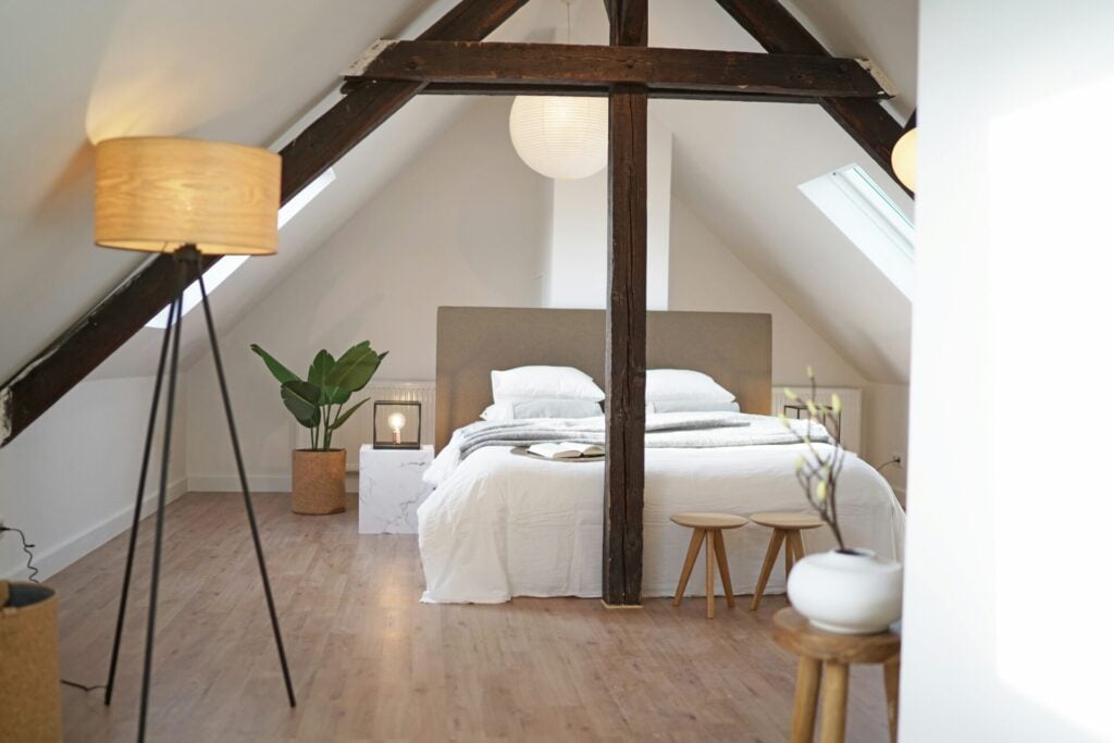 Cozy attic bedroom with wooden beams.