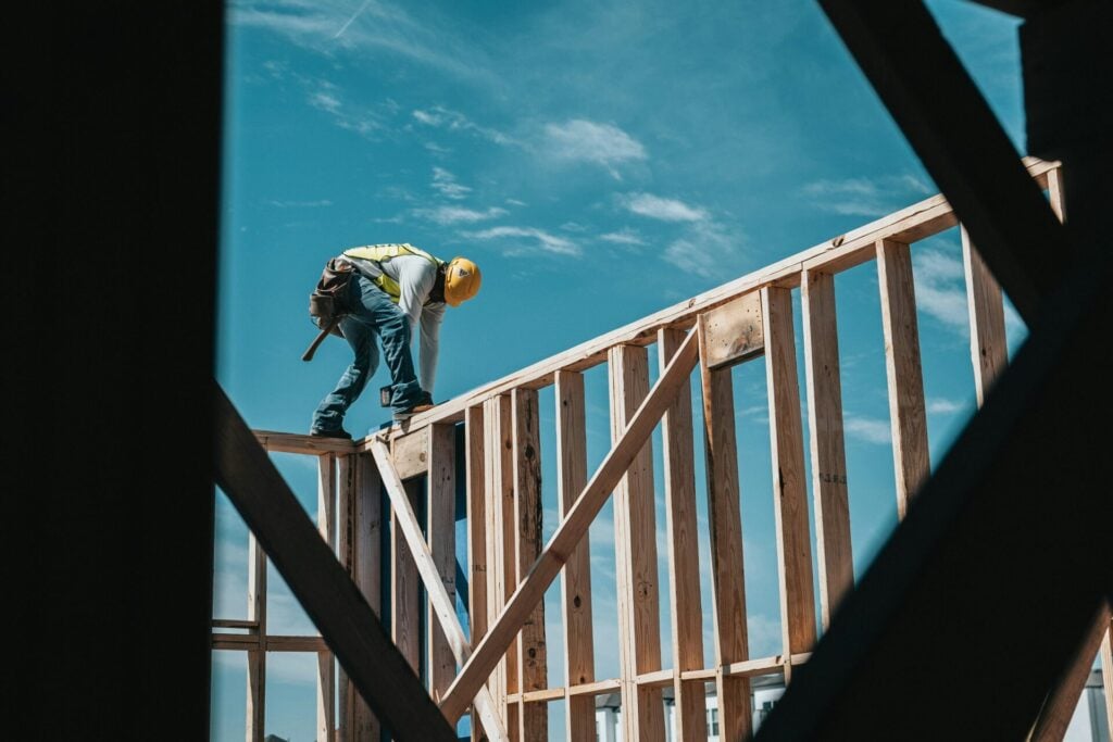 Construction worker on wooden frame
