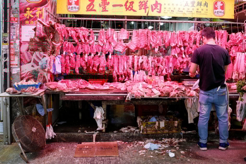 Meat stall with hanging pork cuts typically seen at wildlife markets 