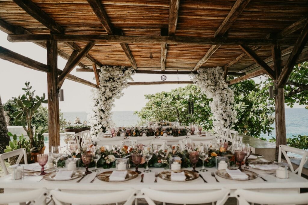 wedding loans can allow couples to create their dream wedding like this beautiful set up of wedding tables under a wooden canopy out in nature
