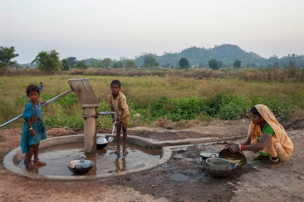 Children drawing water from well.
