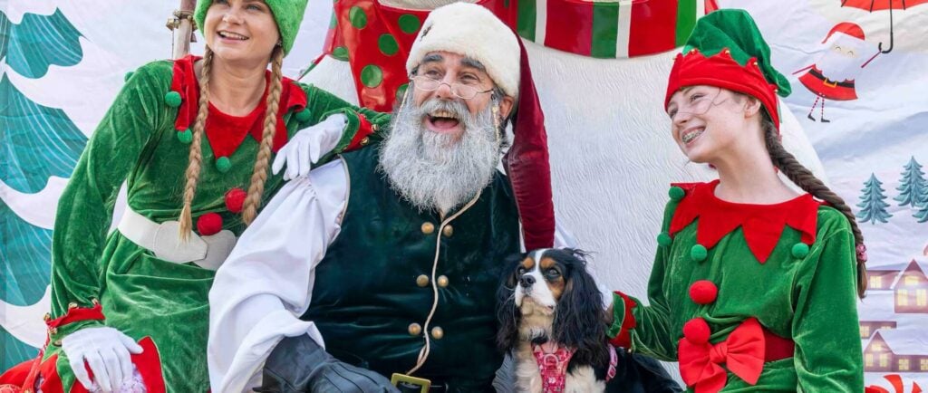 Santa with two elves and dog