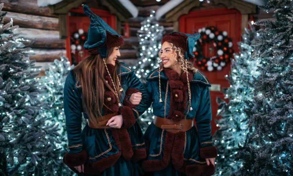 Two people in festive winter attire.
