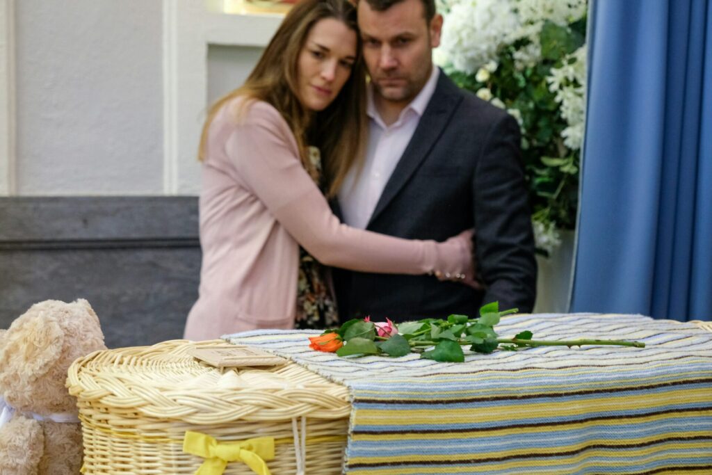 Parents at a funeral after baby loss 