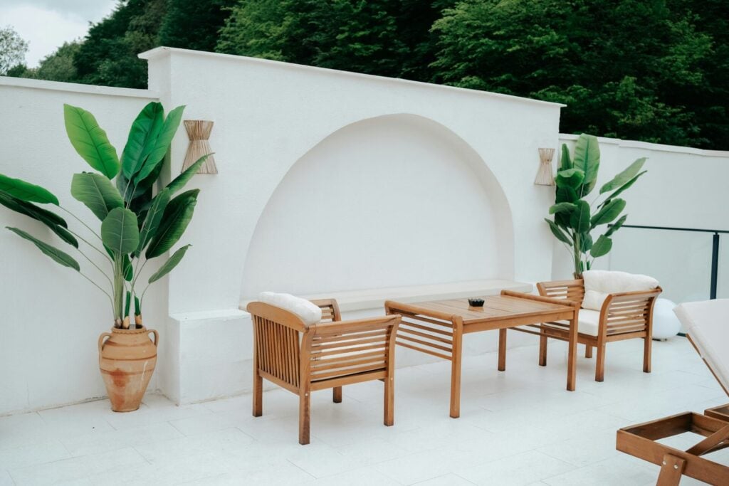 Modern outdoor seating with greenery.