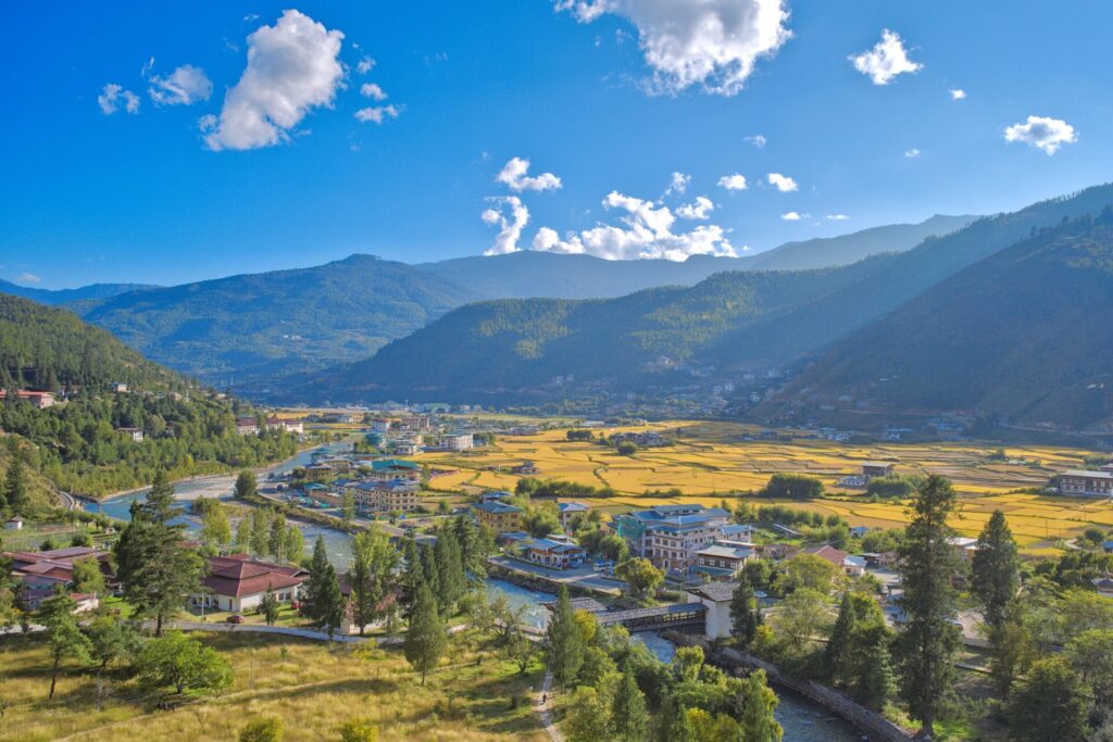 aerial view of Paro in Bhutan with rolling hills and meandering river running through it
