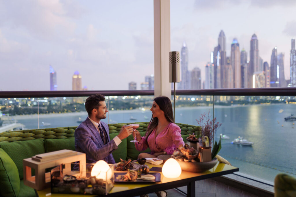 couple toasting in romantic rooftop setting 