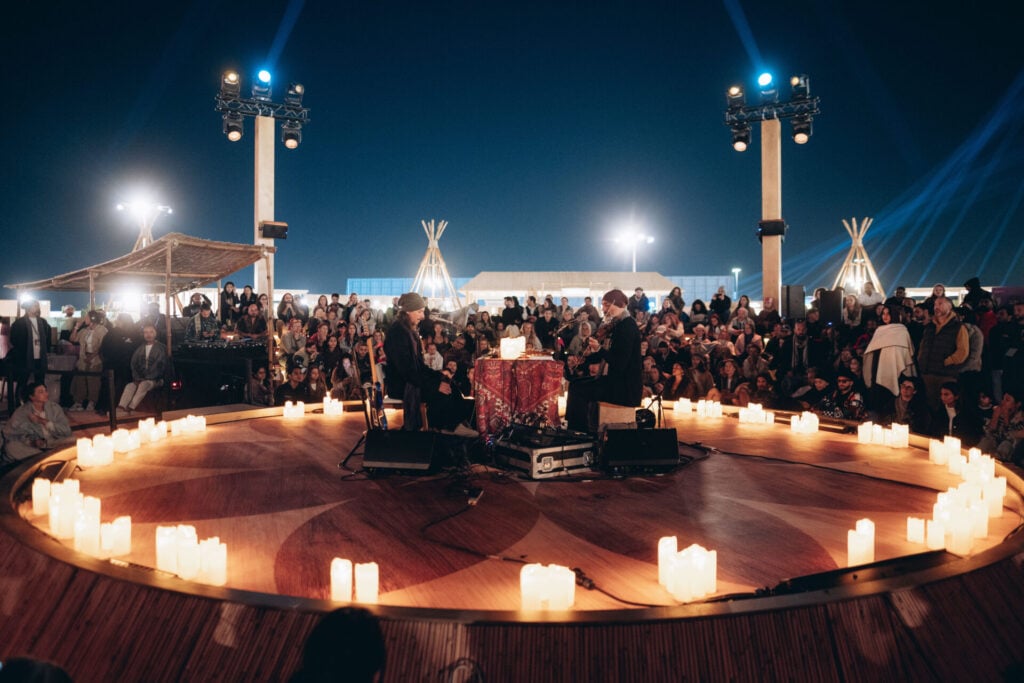 Candlelit performance with large audience