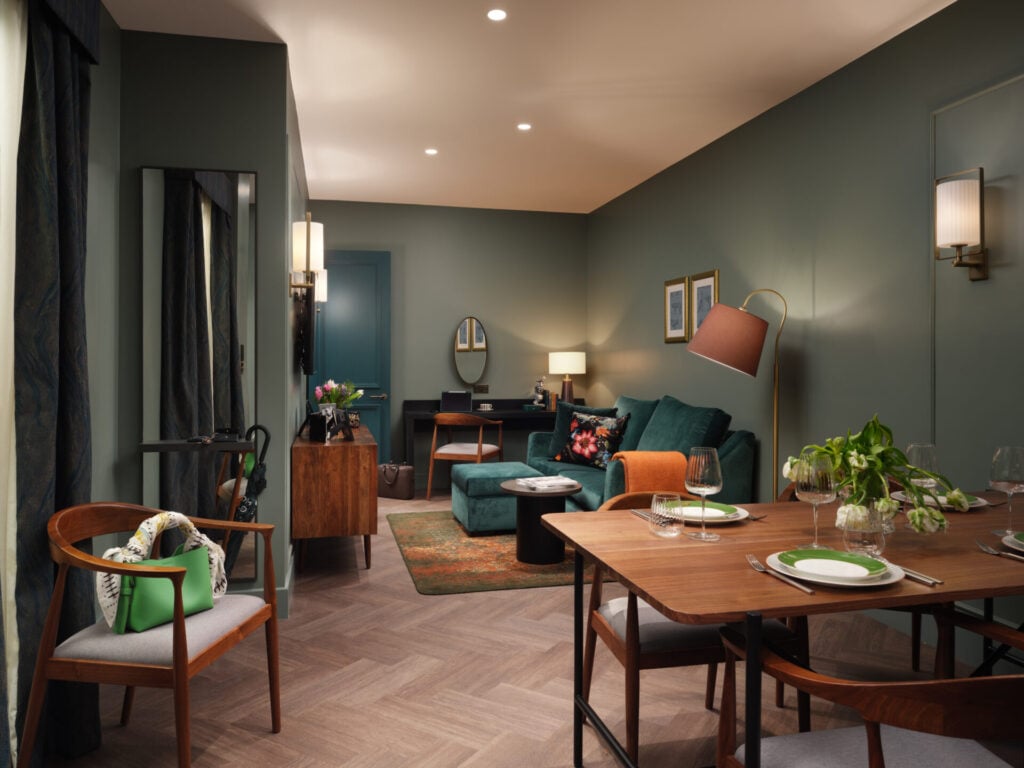 apartment interior with soaf and dining table set for dinner