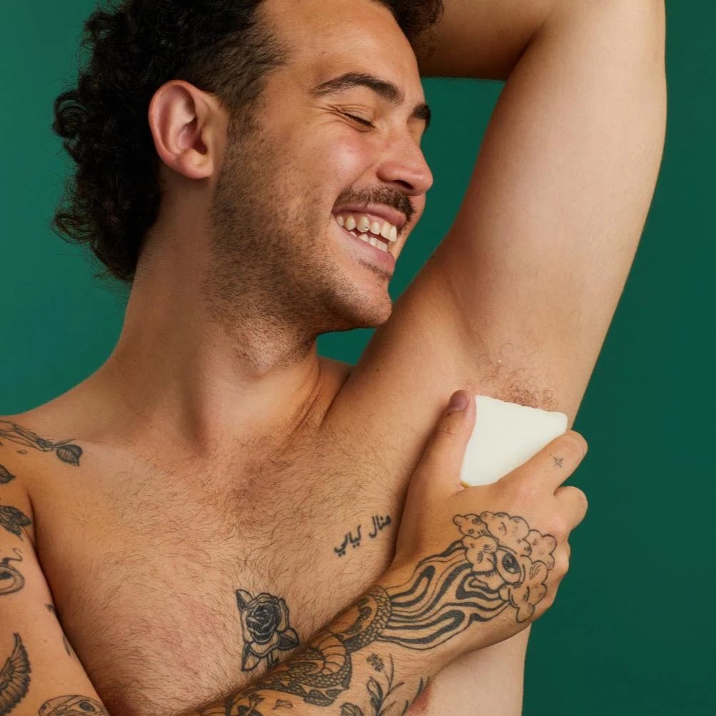 man smiling using natural lush deodorant 