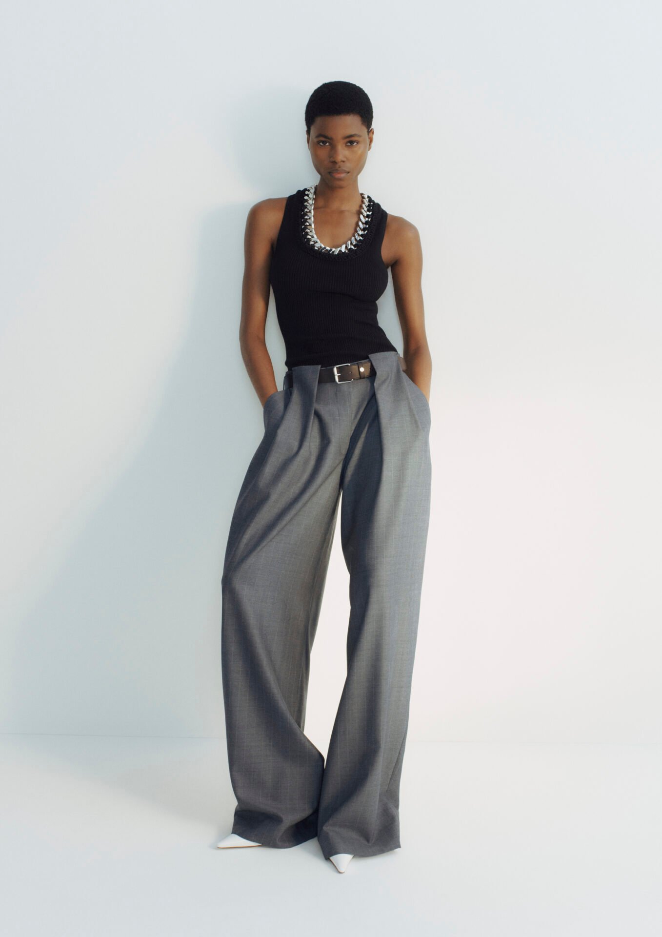 Model wearing Falabella chain v neck rubbed top with pversized grey pants