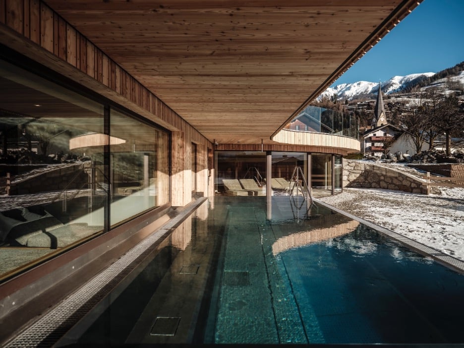 eco pool surrounded by snowy mountains 