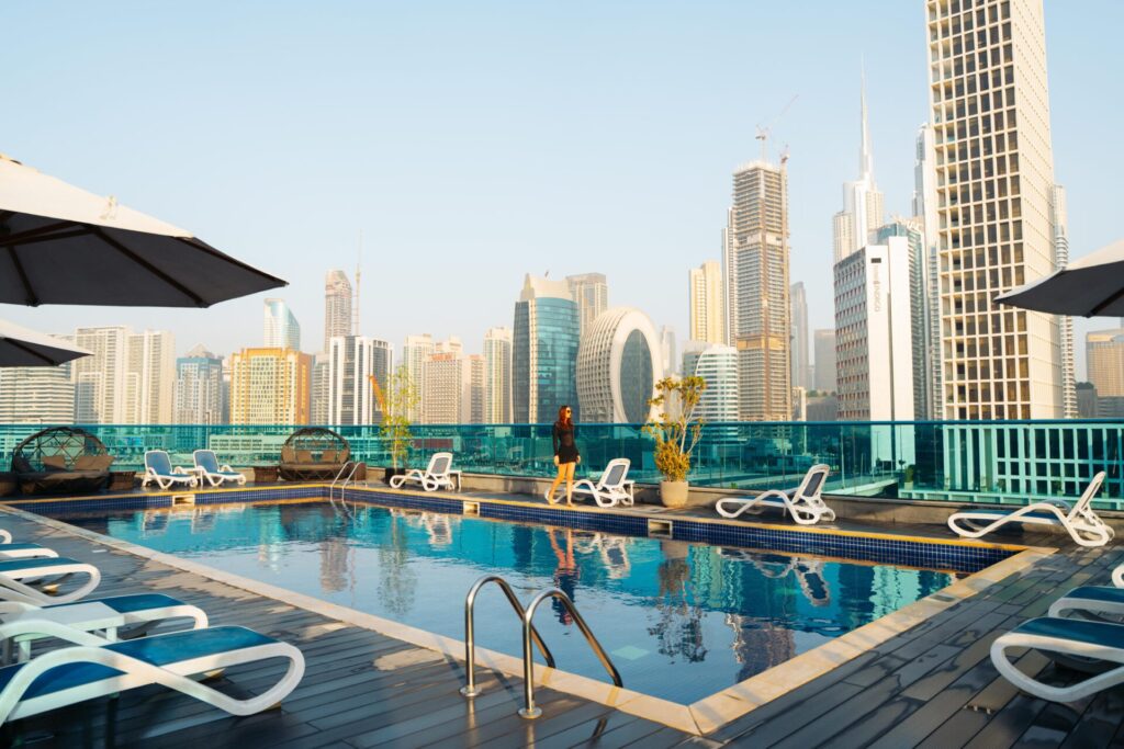 Hotel pool with city skyline 