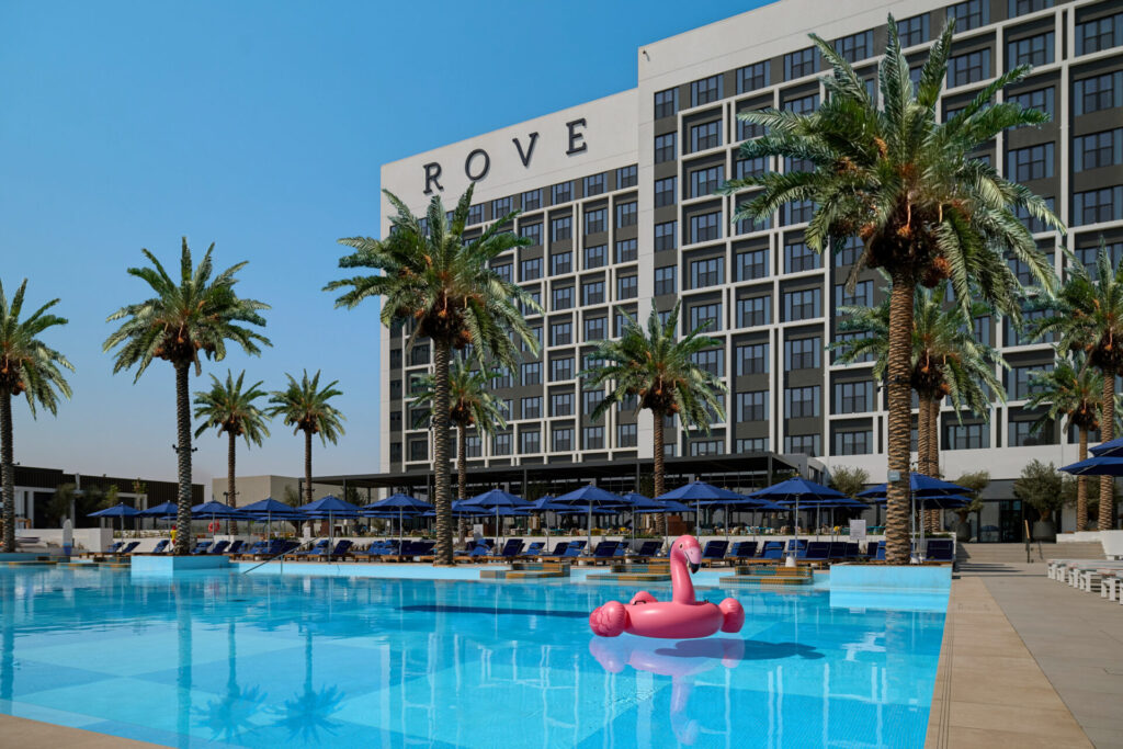 Pool with inflatable pink flamingo in the water 