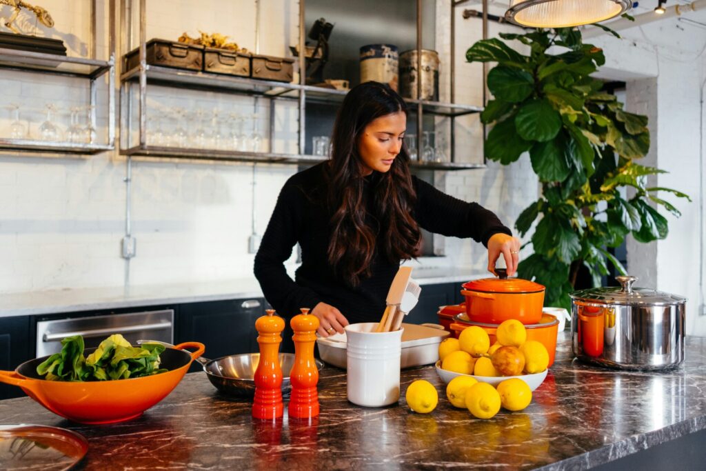 woman cooking with leftover ingredients fro earth day