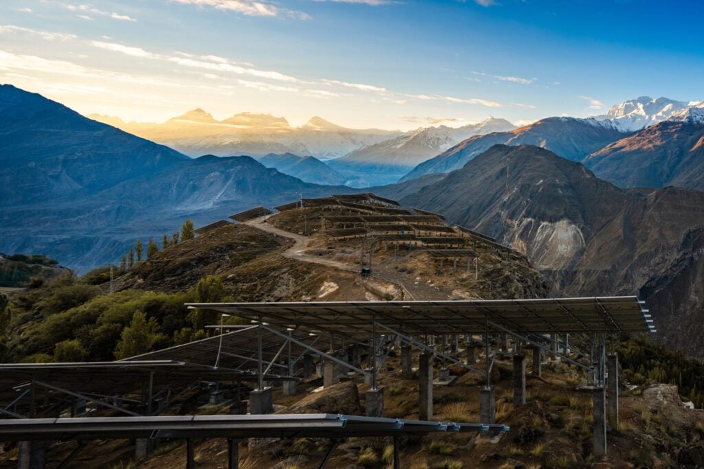 A breathtaking sunrise illuminates this innovative solar panel installation at Duikar Hill Viewpoint in Hunza Valley, Gilgit Baltistan, Pakistan
