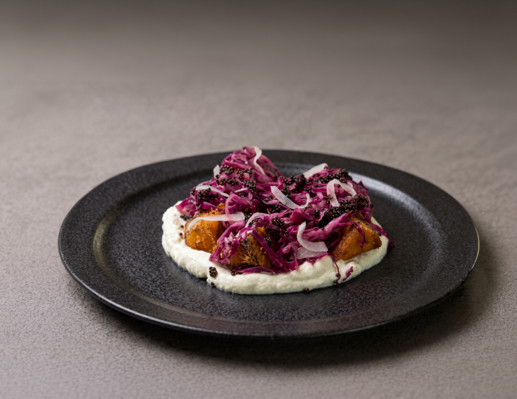 Talabat Mart and Lowe collab dish featuring roasted curried pumpkin layered with sesame yoghurt, sautéed cabbage, pickled mustard and onion
