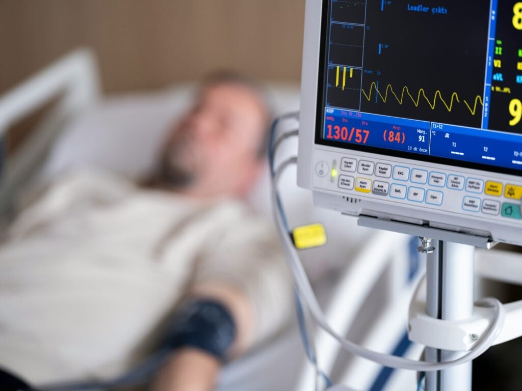 blurred man in ICU bed