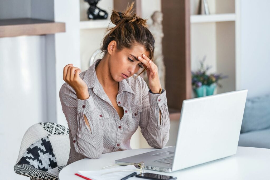 lady holding head suggesting headache