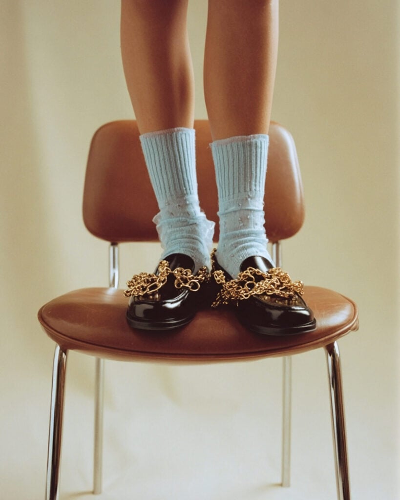 shoes with gold buckles on a chair - as seen on the LUVED website