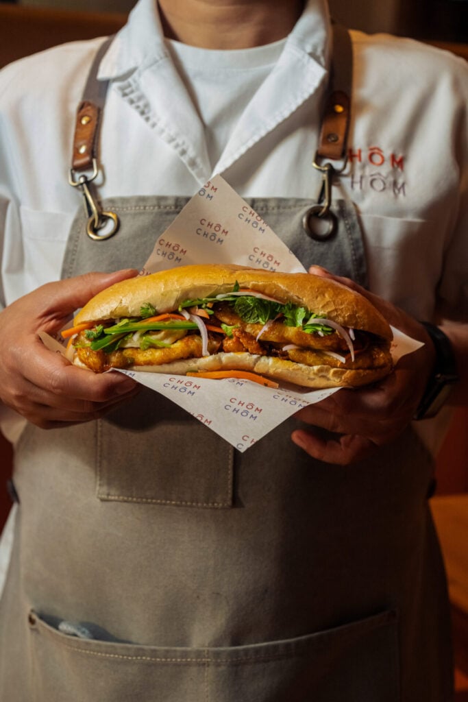 chef holding an egg banh mi from Chôm Chôm