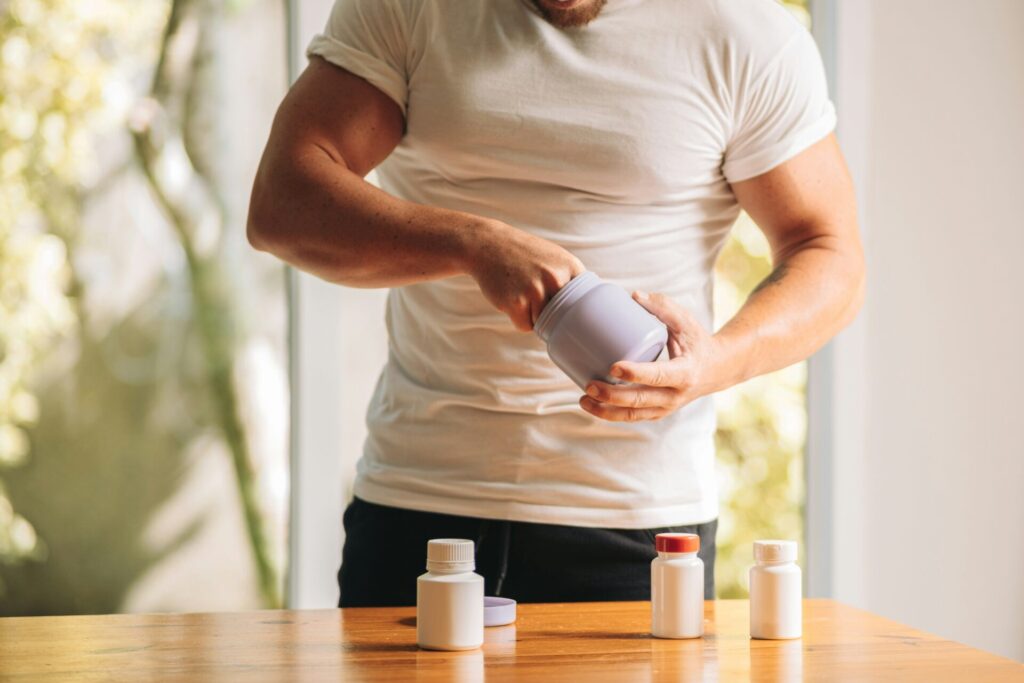 man with hands in supplement jars 