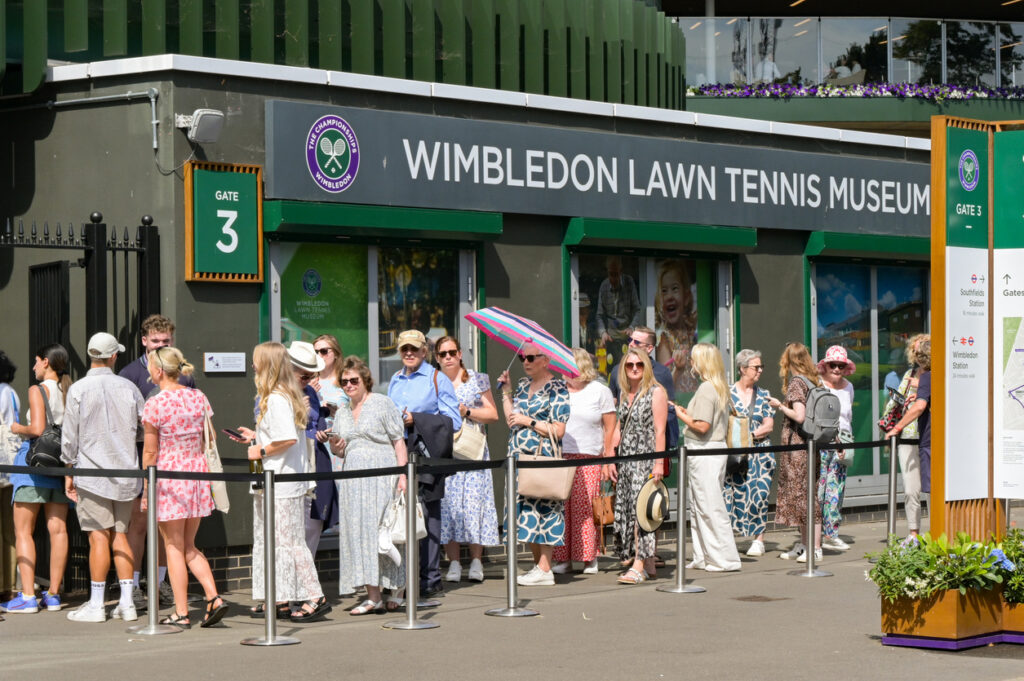 Wimbledon, London, England, UK - 4 July 2025: People queuing on the public road outside the All England Lawn Tennis and Croquet Club to enter the ground.
