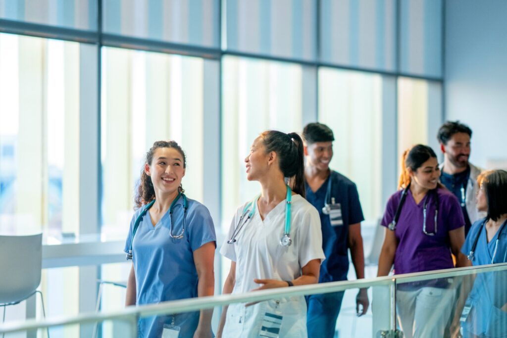 Nurses walking in a hospital laughing and talking