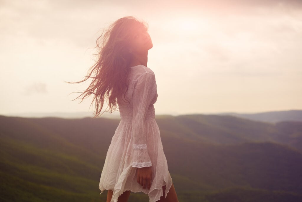 A beautiful woman walking around a mountainside