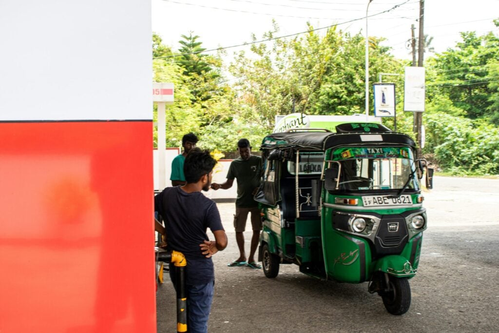 petrol rickshaws filling up at gas station