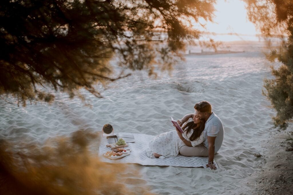 Couple reading together on the beach