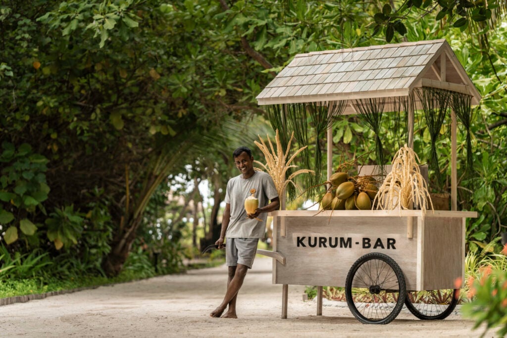 man at Kurum Bar stand with fresh coconuts