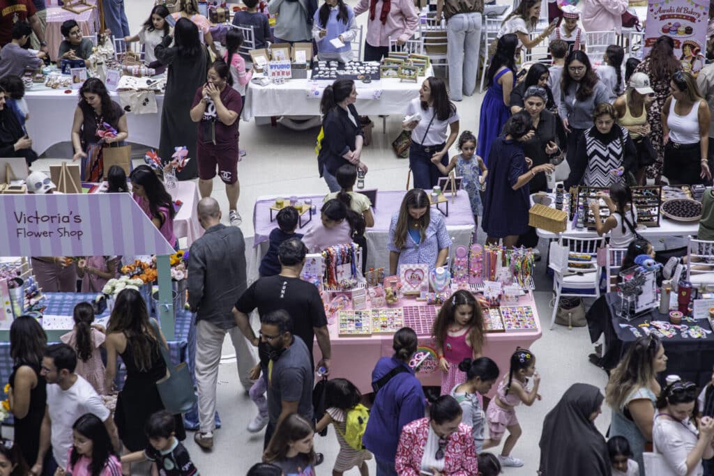 aerial shot of a mini market with stalls run by young people