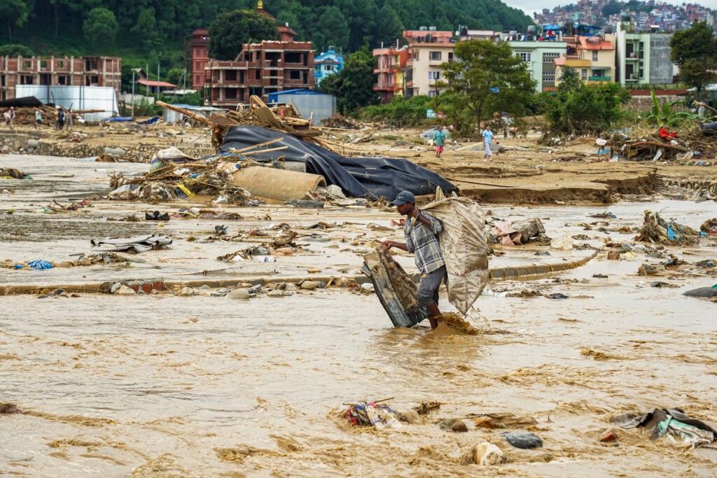 People are gathering their belongings after the flooding of the Nakhu River in Lalitpur, Nepal, on September 29, 2024.