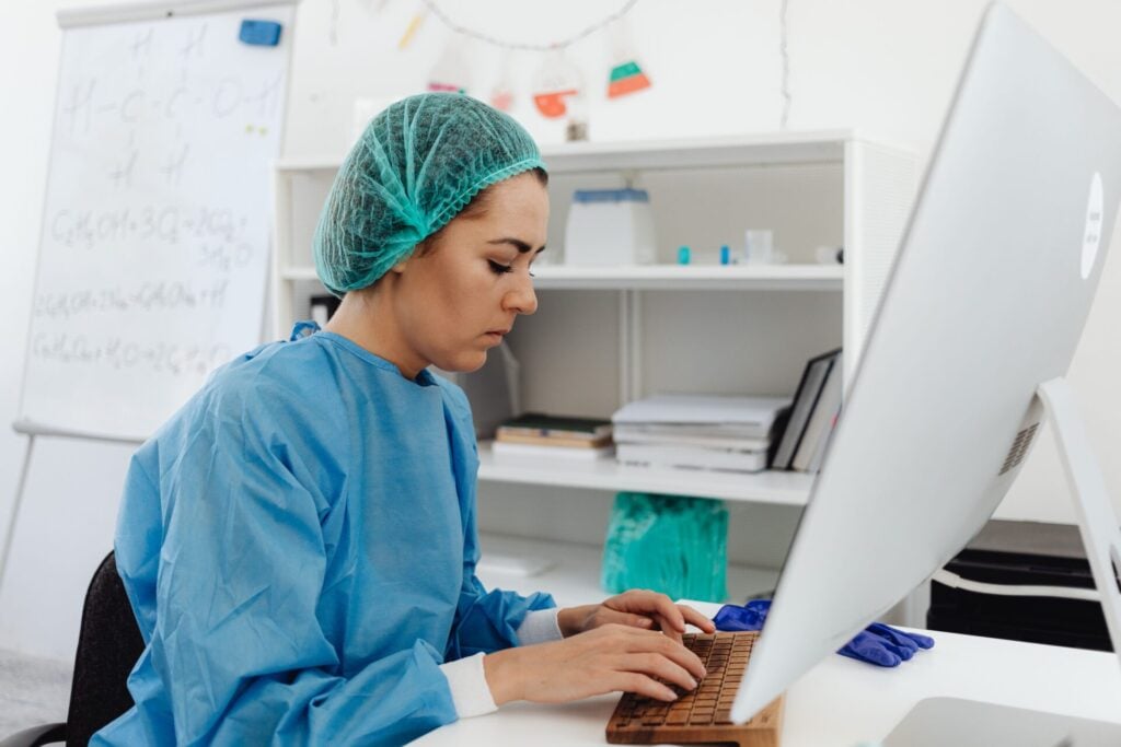 nurse at computer in healthcare setting