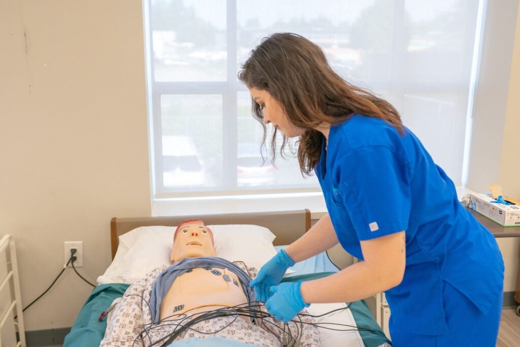 Nurse practicing on dummy