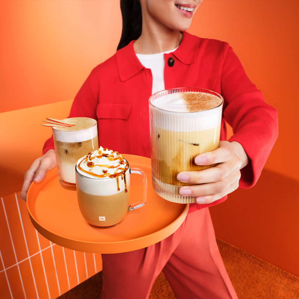Woman holding Nespresso maple pecan iced coffee 
