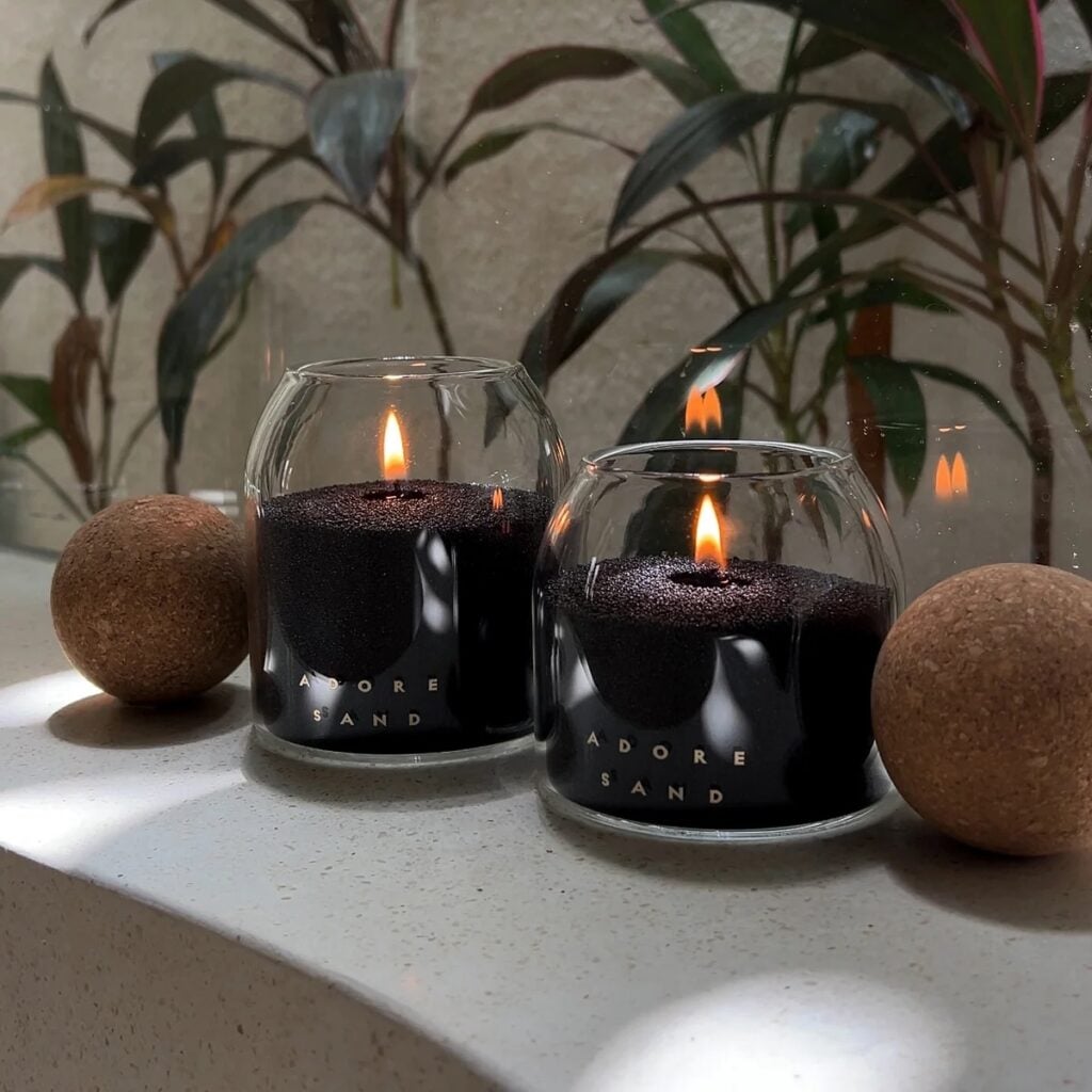 Black candles in artisan glass vessels