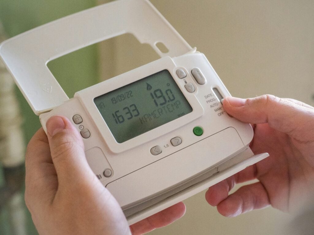 hand holding thermostat