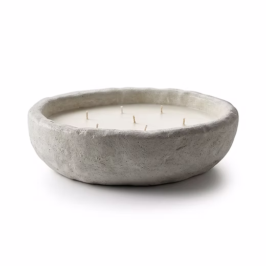 big artisan concrete bowl with candle wax inside and many wicks