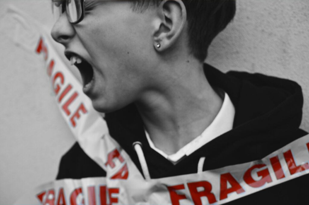 boy tangled in FRAGILE tape screaming